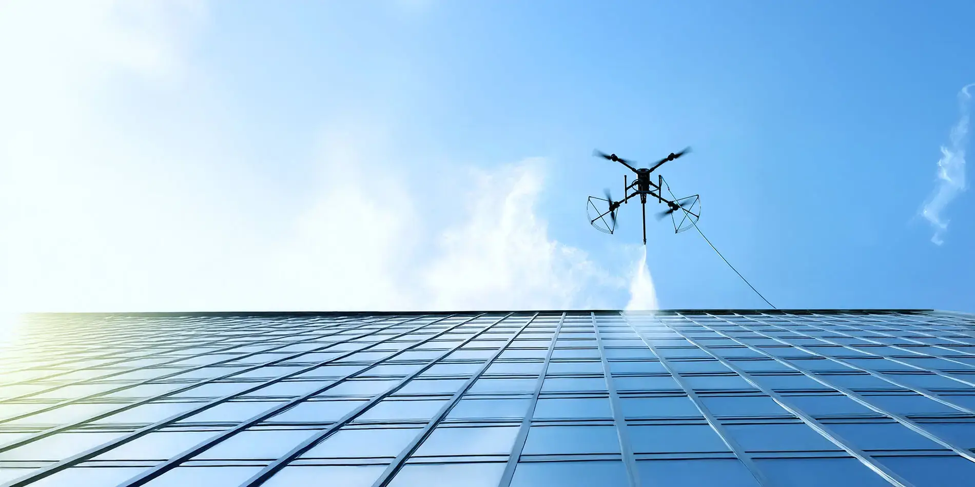 Cleaning aircraft operating above a glazed commercial façade