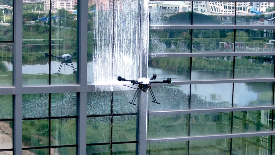 Commercial glass exterior being cleaned by a purpose-built aircraft